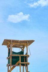 Fototapeta na wymiar Wooden lifeguard tower against a blue sky. Copy space. 