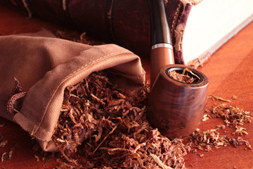 tobacco pipe tobacco pouch lighter and old book - obrazy, fototapety, plakaty