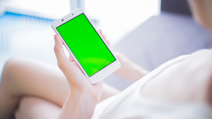 woman using mobile phone on sofa