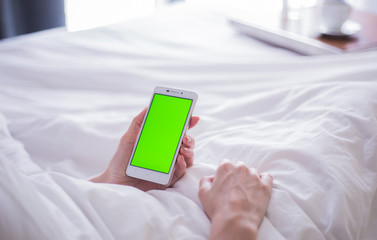 woman using mobile phone on sofa