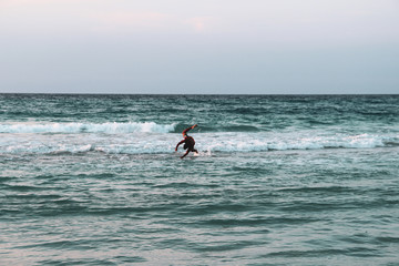 Girl with palm trees sunset in Caribbean