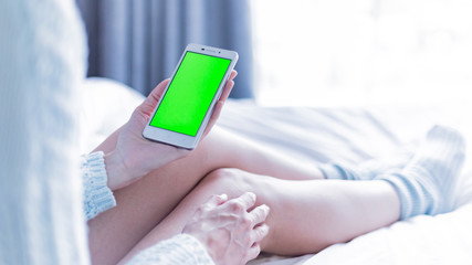 woman using digital tablet in bed