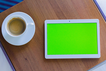cup of coffee and notebook on wooden table