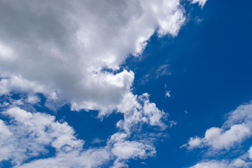 Naklejka na ściany i meble Fluffy White Clouds Floating in a Beautiful Blue Sky 07