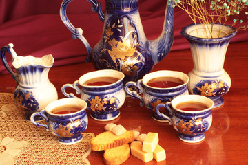 cup of tea and cookies on purple background