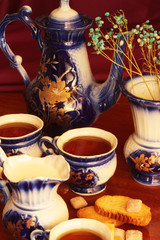 cups of tea with teapot and jug of milk