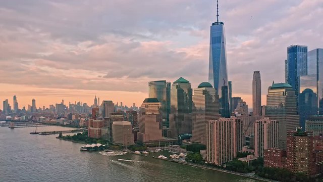 Slow drone rotation around Lower Manhattan skyline at sunset