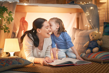 mother and daughter playing in tent