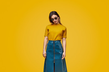 Trendy woman in bright clothes and sunglasses