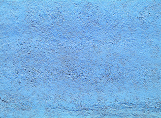 The wall plaster painted blue color textured