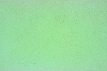 Wall plaster painted green textured