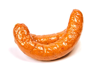 A ring of juicy sausage in a natural casing on a white background. Sausage meat, non-GMO with glitter on a light background.