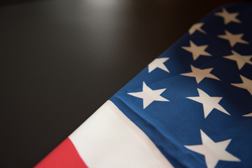 Fototapeta premium American flag close up in dark background with copy space
