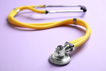 Stethoscope with space for text on color background, closeup. Medical tool