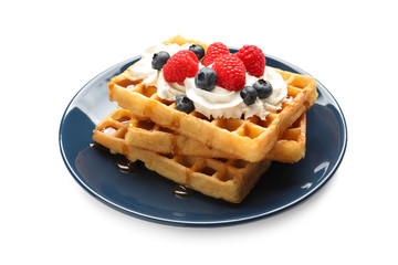 Plate with yummy waffles, whipped cream and berries on white background