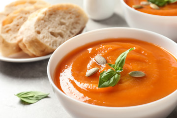 Bowl of tasty sweet potato soup on table, closeup