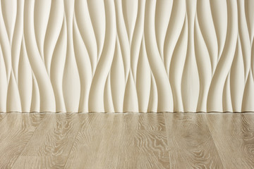 Fragment of the interior with relief 3D panels in the form of waves and laminate