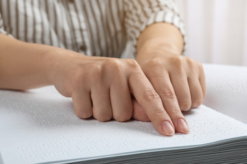 Blind person reading book written in Braille, closeup