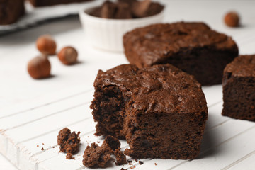 Board with fresh brownies on table, space for text. Delicious chocolate pie