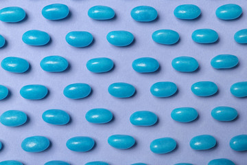 Many delicious jelly beans on color background, flat lay