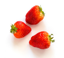 three Red ripe strawberries with shadow isolated on white background