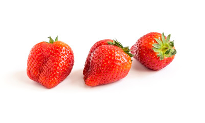 three large red ripe strawberries on white background
