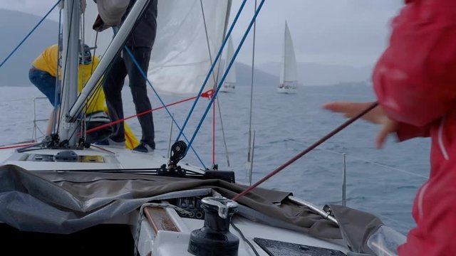 Closeup up of Yachtsman hands pulling rope &nbsp;on sailboat, yacht detail, working on water transport, luxury summer time sport