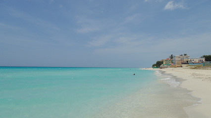 Fototapeta na wymiar Palm trees, white sandy beach and turquoise water in Tulum beach, Mexico