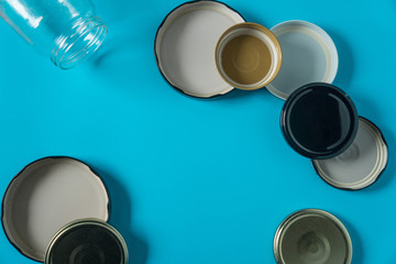 Recycling glass jar lids; Reuse of single use items; Zero no waste recycle program campaigns; Recyclable concept on blank empty copyspace, text room space for copy on horizontal light blue background.