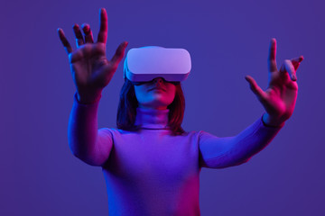 Woman in VR headset gesturing with hands