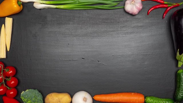 Fresh vegetables frame on the kitchen table. View from top. Space fo text. Stop motion.