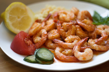 Ready to eat, cooked prawns with vegetables  on a plate. Healthy food.