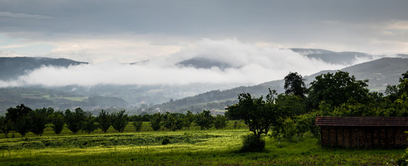 Fototapeta na wymiar Village landscape, cloudy rain day. Village Gruza near the Kragujevac.