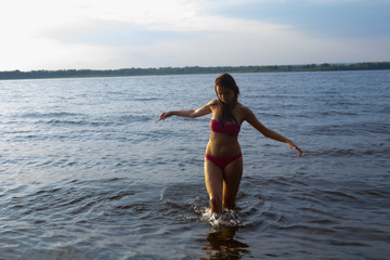 Beautiful Sexy Girl in Pink Bikini Standing and Posing in Water