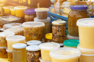 Different natural honey and honeybee products on village fair or farmers market