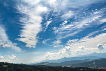 Obraz premium Beautiful clouds over the mountains. Summer landscape. Ukrainian Carpathians