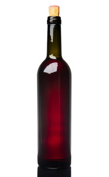 Red wine in a bottle with a cork, isolated on white background