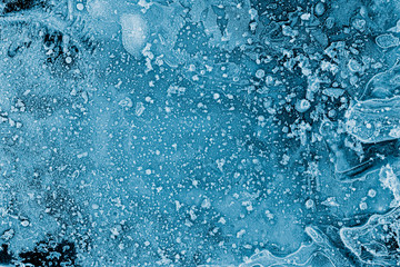 Ice texture background. Textured frosty surface of ice blocks against black.