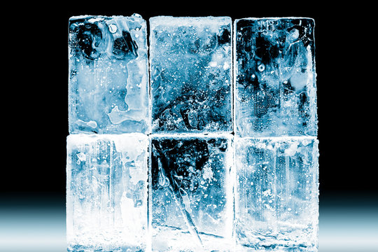 Textured frosty crystal clear ice blocks isolated on black background.