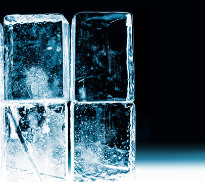 Textured frosty crystal clear ice blocks isolated on black background.