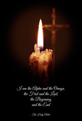A candle and a cross and a quote from the Bible on a dark background.