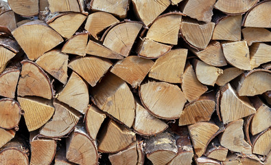 Stacked firewood for kindling a stove, fireplace, barbecue or bonfire. Firewood background. Wood texture.