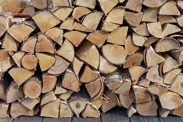 Stacked firewood for kindling a stove, fireplace, barbecue or bonfire. Firewood background. Wood texture.