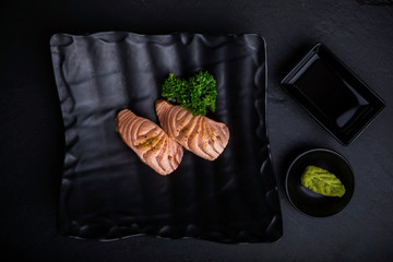 Creative Japanese food menu,sushi Simon Grill.On a black ceramic plate