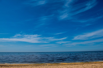 windy sea beach with white sand and blue water