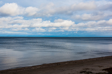 windy sea beach with white sand and blue water