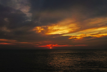 Bright contrast saturated sunset on the ocean on the southern tropical coast.