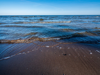windy sea beach with white sand and blue water