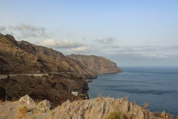 Fototapeta na wymiar Las Gaviotas cliffs of the Anaga mountains partly covered by clouds. Santa Cruz de Tenerife, Canary Islands.