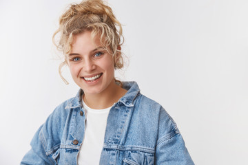 Stylish urban hipster blond scandinavian female student curly hairstyle combed bun smiling laughing carefree having fun enjoying funny sense humor talking standing delighted relaxed white background